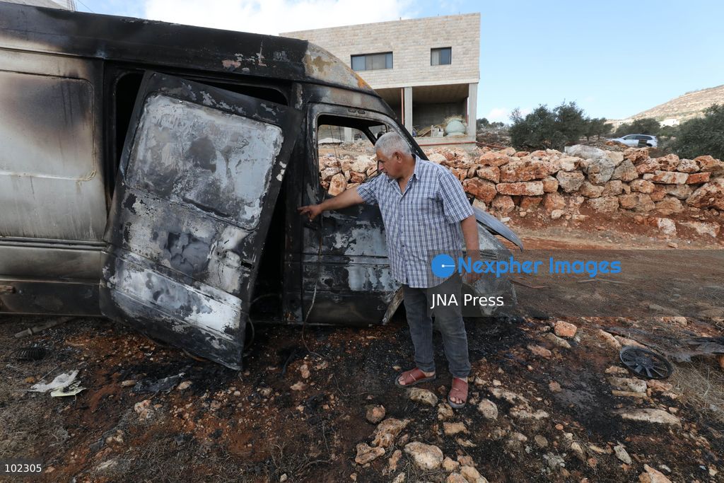 AQRABA, OCCUPIED WEST BANK, OCTOBER 6, 2026: Palestinians inspect vehicles damaged after Israeli settlers attacked the western part of Aqraba, south of Nablus, and set fire to four cars parked outside residents' homes early Tuesday. Aqraba Mayor Salah Jaber said the attackers also spray-painted slogans calling for revenge on property in the area. Photo by Nedal Shtieh / JNA Press. (Photo by Nedal Shtieh/JNA Press via Nexpher Images)