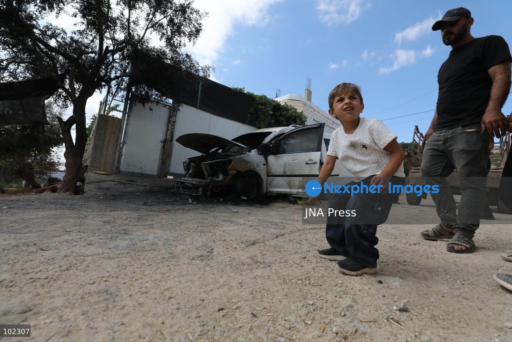 AQRABA, OCCUPIED WEST BANK, OCTOBER 6, 2026: Palestinians inspect vehicles damaged after Israeli settlers attacked the western part of Aqraba, south of Nablus, and set fire to four cars parked outside residents' homes early Tuesday. Aqraba Mayor Salah Jaber said the attackers also spray-painted slogans calling for revenge on property in the area. Photo by Nedal Shtieh / JNA Press. (Photo by Nedal Shtieh/JNA Press via Nexpher Images)