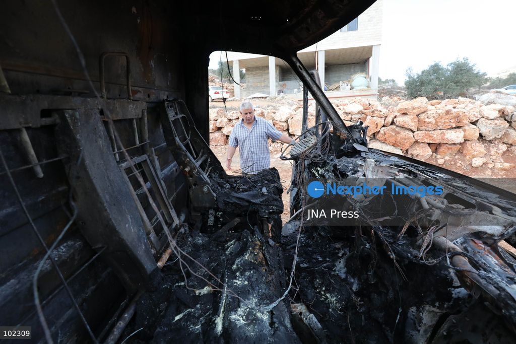 AQRABA, OCCUPIED WEST BANK, OCTOBER 6, 2026: Palestinians inspect vehicles damaged after Israeli settlers attacked the western part of Aqraba, south of Nablus, and set fire to four cars parked outside residents' homes early Tuesday. Aqraba Mayor Salah Jaber said the attackers also spray-painted slogans calling for revenge on property in the area. Photo by Nedal Shtieh / JNA Press. (Photo by Nedal Shtieh/JNA Press via Nexpher Images)