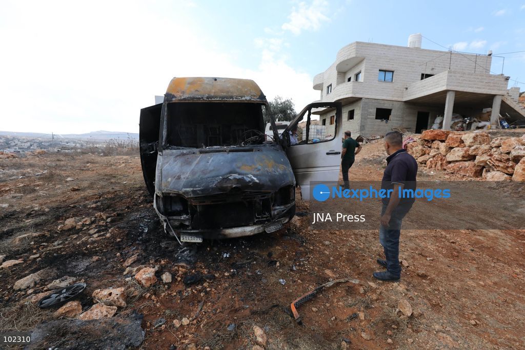 AQRABA, OCCUPIED WEST BANK, OCTOBER 6, 2026: Palestinians inspect vehicles damaged after Israeli settlers attacked the western part of Aqraba, south of Nablus, and set fire to four cars parked outside residents' homes early Tuesday. Aqraba Mayor Salah Jaber said the attackers also spray-painted slogans calling for revenge on property in the area. Photo by Nedal Shtieh / JNA Press. (Photo by Nedal Shtieh/JNA Press via Nexpher Images)
