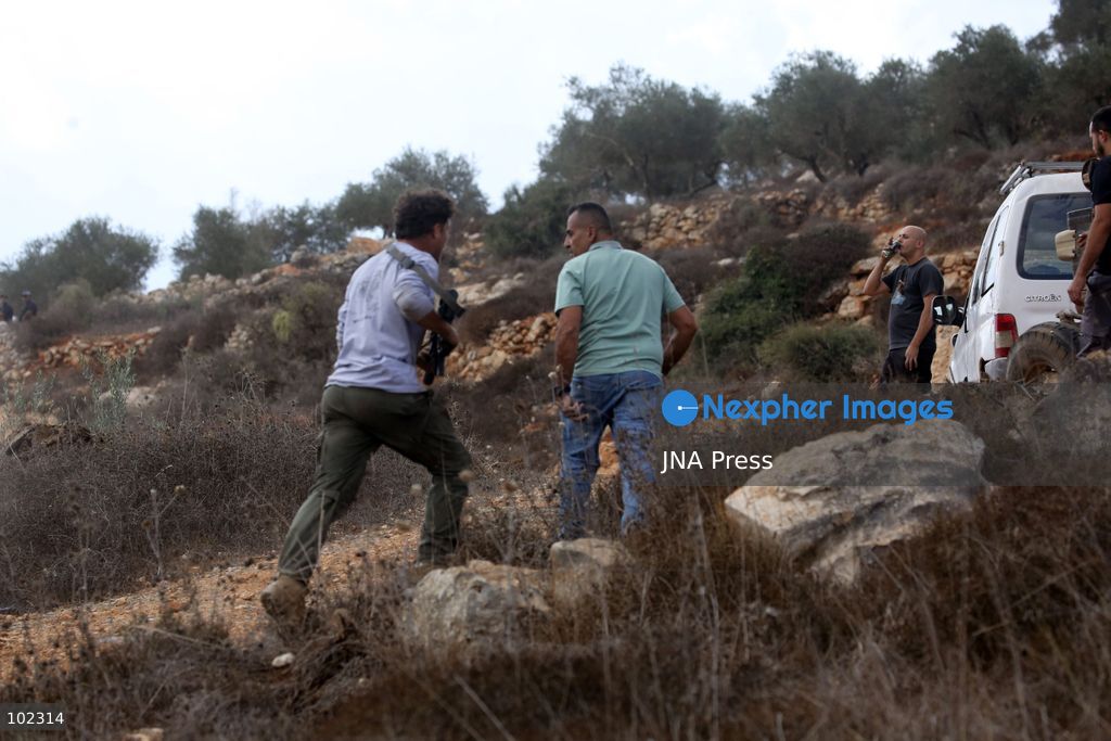 AQRABA, OCCUPIED WEST BANK, OCTOBER 6, 2026: Palestinian farmers come under attack by Israeli settlers while harvesting olives in the village of Aqraba, south of Nablus. Several Palestinians were wounded after settlers opened fire and assaulted farmers during the harvest, according to Palestinian reports. Israeli forces later detained a Palestinian farmer at the scene, according to information provided by the photographer. The Israeli military had not immediately commented on the reported shooting. Photo by Nedal Shtieh/ JNA Press. (Photo by Nedal Shtieh/JNA Press via Nexpher Images)