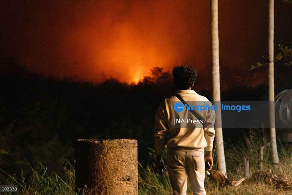 JAMBI, INDONESIA, OCTOBER 6, 2026: Firefighters battle a land fire burning through trees and vegetation in the Penyengat Rendah area of Jambi City, as local residents observe the blaze. Forest and land fires across parts of Jambi and Sumatra continue to affect air quality and raise environmental concerns during the dry season. Photo by Prabanndaru Wahyuaji / JNA Press. (Photo by Prabanndaru Wahyuaji/JNA Press via Nexpher Images)