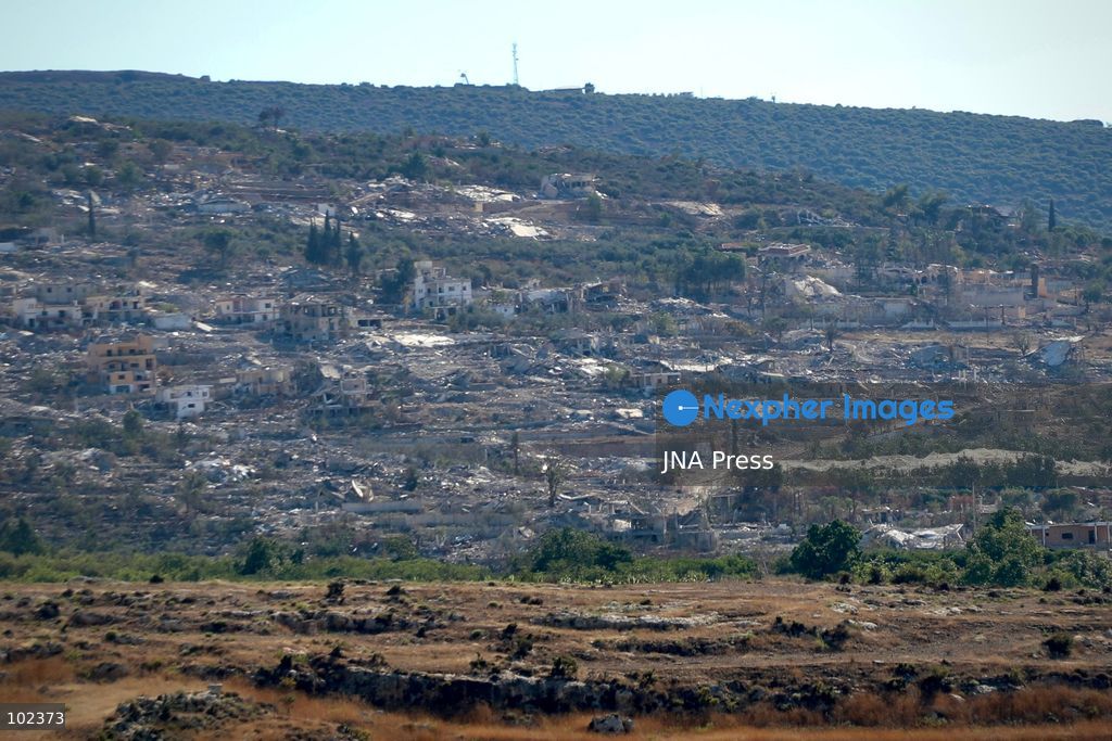 HANNIYEH, SOUTH LEBANON, OCTOBER 6, 2026: Displaced residents of Mansouri watch from the nearby village of Hanniyeh as an Israeli strike hits their home village in southern Lebanon. Residents gather at the vantage point as Israeli attacks and demolitions continue in Mansouri, using mobile phone cameras and zoom lenses to try to identify which homes or buildings have been hit. Mansouri residents have been displaced from the village amid continuing Israeli military operations in the area. Photo by Amanda Flybjerg / JNA PRES (Photo by Amanda Flyvbjerg/JNA Press via Nexpher Images)