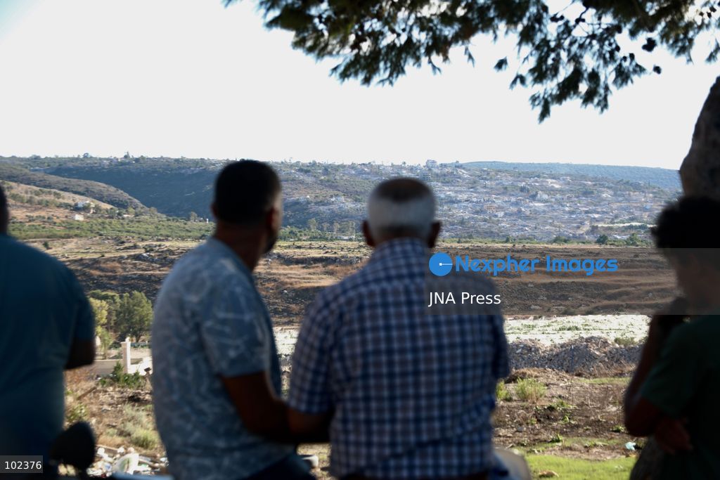 HANNIYEH, SOUTH LEBANON, OCTOBER 6, 2026: Displaced residents of Mansouri watch from the nearby village of Hanniyeh as an Israeli strike hits their home village in southern Lebanon. Residents gather at the vantage point as Israeli attacks and demolitions continue in Mansouri, using mobile phone cameras and zoom lenses to try to identify which homes or buildings have been hit. Mansouri residents have been displaced from the village amid continuing Israeli military operations in the area. Photo by Amanda Flybjerg / JNA PRES (Photo by Amanda Flyvbjerg/JNA Press via Nexpher Images)