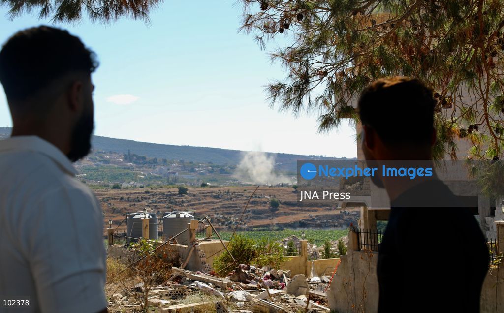 HANNIYEH, SOUTH LEBANON, OCTOBER 6, 2026: Displaced residents of Mansouri watch from the nearby village of Hanniyeh as an Israeli strike hits their home village in southern Lebanon. Residents gather at the vantage point as Israeli attacks and demolitions continue in Mansouri, using mobile phone cameras and zoom lenses to try to identify which homes or buildings have been hit. Mansouri residents have been displaced from the village amid continuing Israeli military operations in the area. Photo by Amanda Flybjerg / JNA PRES (Photo by Amanda Flyvbjerg/JNA Press via Nexpher Images)