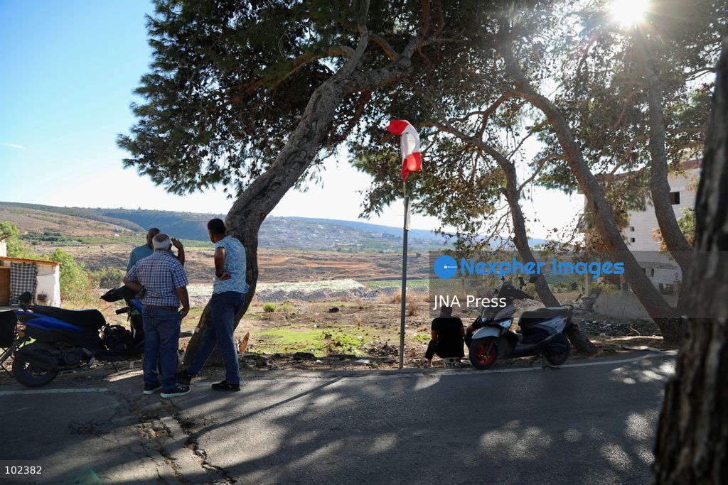 HANNIYEH, SOUTH LEBANON, OCTOBER 6, 2026: Displaced residents of Mansouri watch from the nearby village of Hanniyeh as an Israeli strike hits their home village in southern Lebanon. Residents gather at the vantage point as Israeli attacks and demolitions continue in Mansouri, using mobile phone cameras and zoom lenses to try to identify which homes or buildings have been hit. Mansouri residents have been displaced from the village amid continuing Israeli military operations in the area. Photo by Amanda Flybjerg / JNA PRES (Photo by Amanda Flyvbjerg/JNA Press via Nexpher Images)