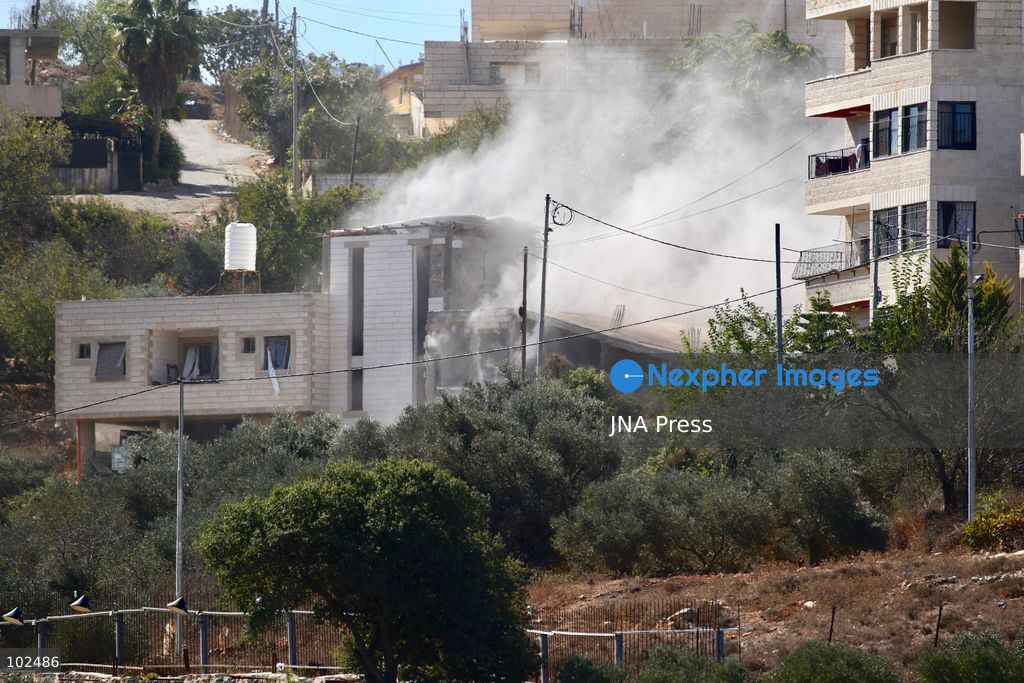 BIDDU, OCCUPIED WEST BANK, OCTOBER 7, 2026: Israeli forces accompanied by military bulldozers and engineering units demolish the home of Palestinian prisoner Qadri Samara in Biddu, northwest of Jerusalem. Israeli forces evacuated the house and surrounding homes before demolishing parts of the building and destroying it with controlled explosions. Israeli authorities accuse Samara of carrying out a shooting attack near the Israeli settlement of Neve Tzuf, also known as Halamish, in which an Israeli was killed. The demolition took place during a wider Israeli military operation involving raids, arrests and movement restrictions in several Palestinian towns and villages northwest of Jerusalem. Photo by Salman Mohsen Alkhatib / JNA Press. (Photo by Salman Mohsen Alkhatib/JNA Press via Nexpher Images)