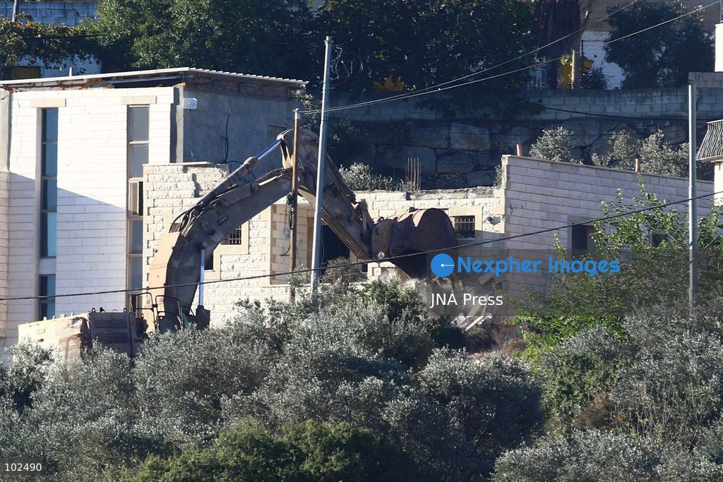 BIDDU, OCCUPIED WEST BANK, OCTOBER 7, 2026: Israeli forces accompanied by military bulldozers and engineering units demolish the home of Palestinian prisoner Qadri Samara in Biddu, northwest of Jerusalem. Israeli forces evacuated the house and surrounding homes before demolishing parts of the building and destroying it with controlled explosions. Israeli authorities accuse Samara of carrying out a shooting attack near the Israeli settlement of Neve Tzuf, also known as Halamish, in which an Israeli was killed. The demolition took place during a wider Israeli military operation involving raids, arrests and movement restrictions in several Palestinian towns and villages northwest of Jerusalem. Photo by Salman Mohsen Alkhatib / JNA Press. (Photo by Salman Mohsen Alkhatib/JNA Press via Nexpher Images)