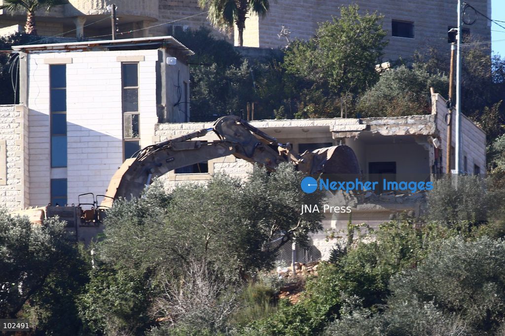 BIDDU, OCCUPIED WEST BANK, OCTOBER 7, 2026: Israeli forces accompanied by military bulldozers and engineering units demolish the home of Palestinian prisoner Qadri Samara in Biddu, northwest of Jerusalem. Israeli forces evacuated the house and surrounding homes before demolishing parts of the building and destroying it with controlled explosions. Israeli authorities accuse Samara of carrying out a shooting attack near the Israeli settlement of Neve Tzuf, also known as Halamish, in which an Israeli was killed. The demolition took place during a wider Israeli military operation involving raids, arrests and movement restrictions in several Palestinian towns and villages northwest of Jerusalem. Photo by Salman Mohsen Alkhatib / JNA Press. (Photo by Salman Mohsen Alkhatib/JNA Press via Nexpher Images)