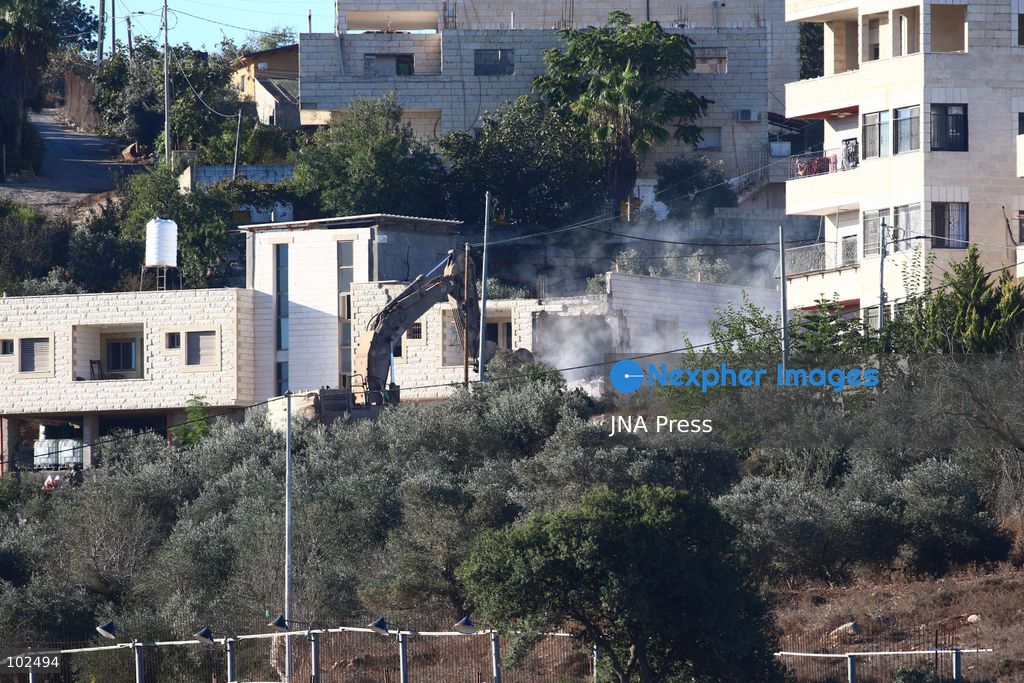 BIDDU, OCCUPIED WEST BANK, OCTOBER 7, 2026: Israeli forces accompanied by military bulldozers and engineering units demolish the home of Palestinian prisoner Qadri Samara in Biddu, northwest of Jerusalem. Israeli forces evacuated the house and surrounding homes before demolishing parts of the building and destroying it with controlled explosions. Israeli authorities accuse Samara of carrying out a shooting attack near the Israeli settlement of Neve Tzuf, also known as Halamish, in which an Israeli was killed. The demolition took place during a wider Israeli military operation involving raids, arrests and movement restrictions in several Palestinian towns and villages northwest of Jerusalem. Photo by Salman Mohsen Alkhatib / JNA Press. (Photo by Salman Mohsen Alkhatib/JNA Press via Nexpher Images)