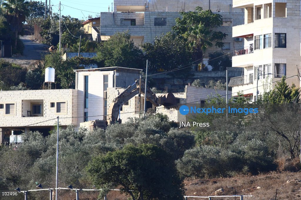 BIDDU, OCCUPIED WEST BANK, OCTOBER 7, 2026: Israeli forces accompanied by military bulldozers and engineering units demolish the home of Palestinian prisoner Qadri Samara in Biddu, northwest of Jerusalem. Israeli forces evacuated the house and surrounding homes before demolishing parts of the building and destroying it with controlled explosions. Israeli authorities accuse Samara of carrying out a shooting attack near the Israeli settlement of Neve Tzuf, also known as Halamish, in which an Israeli was killed. The demolition took place during a wider Israeli military operation involving raids, arrests and movement restrictions in several Palestinian towns and villages northwest of Jerusalem. Photo by Salman Mohsen Alkhatib / JNA Press. (Photo by Salman Mohsen Alkhatib/JNA Press via Nexpher Images)