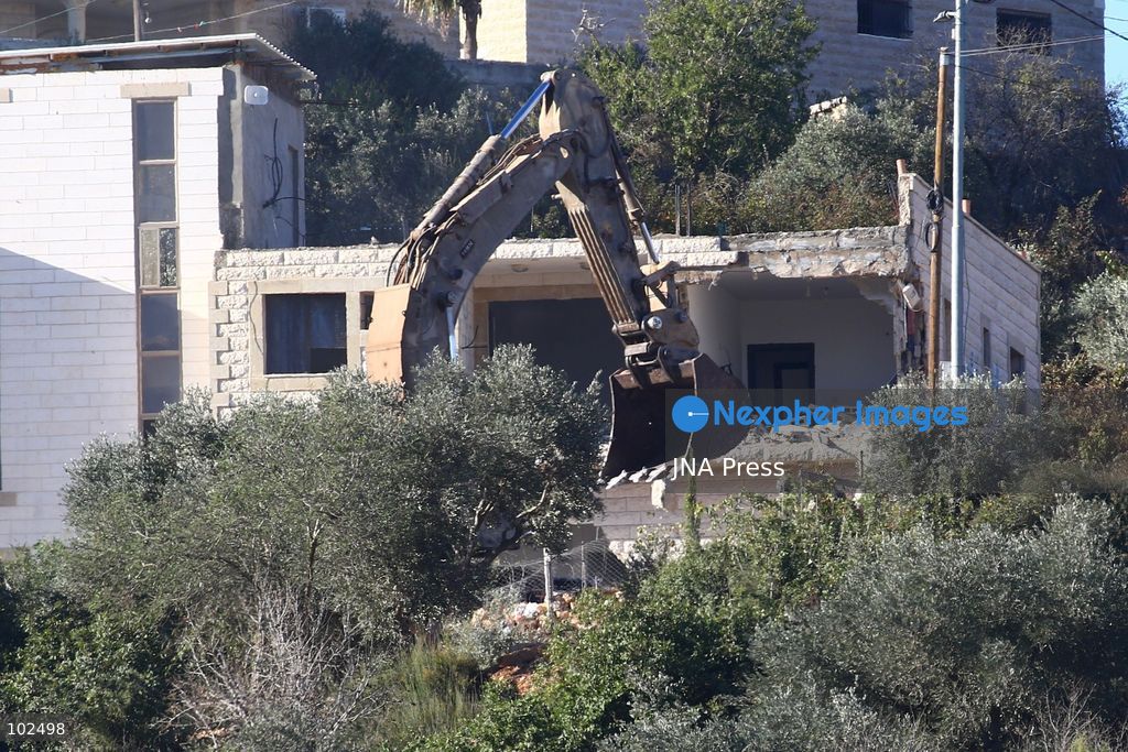 BIDDU, OCCUPIED WEST BANK, OCTOBER 7, 2026: Israeli forces accompanied by military bulldozers and engineering units demolish the home of Palestinian prisoner Qadri Samara in Biddu, northwest of Jerusalem. Israeli forces evacuated the house and surrounding homes before demolishing parts of the building and destroying it with controlled explosions. Israeli authorities accuse Samara of carrying out a shooting attack near the Israeli settlement of Neve Tzuf, also known as Halamish, in which an Israeli was killed. The demolition took place during a wider Israeli military operation involving raids, arrests and movement restrictions in several Palestinian towns and villages northwest of Jerusalem. Photo by Salman Mohsen Alkhatib / JNA Press. (Photo by Salman Mohsen Alkhatib/JNA Press via Nexpher Images)