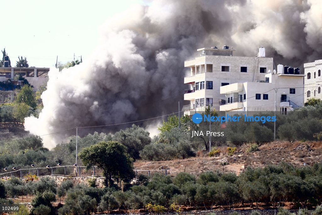 BIDDU, OCCUPIED WEST BANK, OCTOBER 7, 2026: Israeli forces accompanied by military bulldozers and engineering units demolish the home of Palestinian prisoner Qadri Samara in Biddu, northwest of Jerusalem. Israeli forces evacuated the house and surrounding homes before demolishing parts of the building and destroying it with controlled explosions. Israeli authorities accuse Samara of carrying out a shooting attack near the Israeli settlement of Neve Tzuf, also known as Halamish, in which an Israeli was killed. The demolition took place during a wider Israeli military operation involving raids, arrests and movement restrictions in several Palestinian towns and villages northwest of Jerusalem. Photo by Salman Mohsen Alkhatib / JNA Press. (Photo by Salman Mohsen Alkhatib/JNA Press via Nexpher Images)