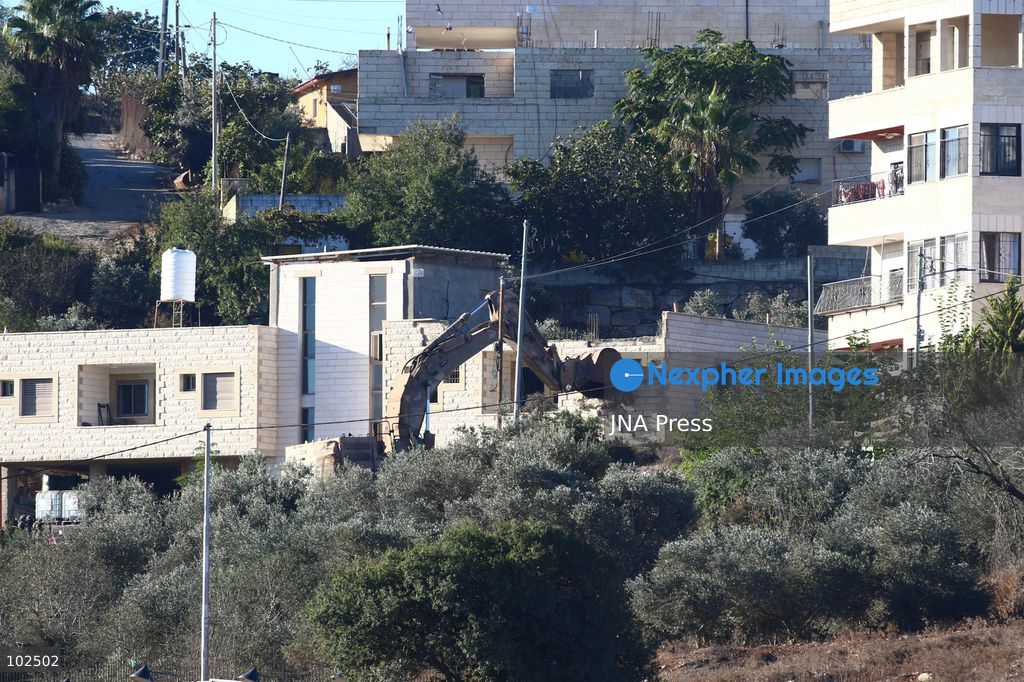 BIDDU, OCCUPIED WEST BANK, OCTOBER 7, 2026: Israeli forces accompanied by military bulldozers and engineering units demolish the home of Palestinian prisoner Qadri Samara in Biddu, northwest of Jerusalem. Israeli forces evacuated the house and surrounding homes before demolishing parts of the building and destroying it with controlled explosions. Israeli authorities accuse Samara of carrying out a shooting attack near the Israeli settlement of Neve Tzuf, also known as Halamish, in which an Israeli was killed. The demolition took place during a wider Israeli military operation involving raids, arrests and movement restrictions in several Palestinian towns and villages northwest of Jerusalem. Photo by Salman Mohsen Alkhatib / JNA Press. (Photo by Salman Mohsen Alkhatib/JNA Press via Nexpher Images)