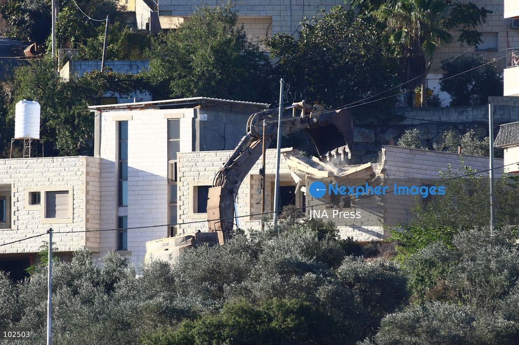 BIDDU, OCCUPIED WEST BANK, OCTOBER 7, 2026: Israeli forces accompanied by military bulldozers and engineering units demolish the home of Palestinian prisoner Qadri Samara in Biddu, northwest of Jerusalem. Israeli forces evacuated the house and surrounding homes before demolishing parts of the building and destroying it with controlled explosions. Israeli authorities accuse Samara of carrying out a shooting attack near the Israeli settlement of Neve Tzuf, also known as Halamish, in which an Israeli was killed. The demolition took place during a wider Israeli military operation involving raids, arrests and movement restrictions in several Palestinian towns and villages northwest of Jerusalem. Photo by Salman Mohsen Alkhatib / JNA Press. (Photo by Salman Mohsen Alkhatib/JNA Press via Nexpher Images)