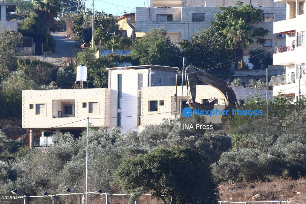 BIDDU, OCCUPIED WEST BANK, OCTOBER 7, 2026: Israeli forces accompanied by military bulldozers and engineering units demolish the home of Palestinian prisoner Qadri Samara in Biddu, northwest of Jerusalem. Israeli forces evacuated the house and surrounding homes before demolishing parts of the building and destroying it with controlled explosions. Israeli authorities accuse Samara of carrying out a shooting attack near the Israeli settlement of Neve Tzuf, also known as Halamish, in which an Israeli was killed. The demolition took place during a wider Israeli military operation involving raids, arrests and movement restrictions in several Palestinian towns and villages northwest of Jerusalem. Photo by Salman Mohsen Alkhatib / JNA Press. (Photo by Salman Mohsen Alkhatib/JNA Press via Nexpher Images)
