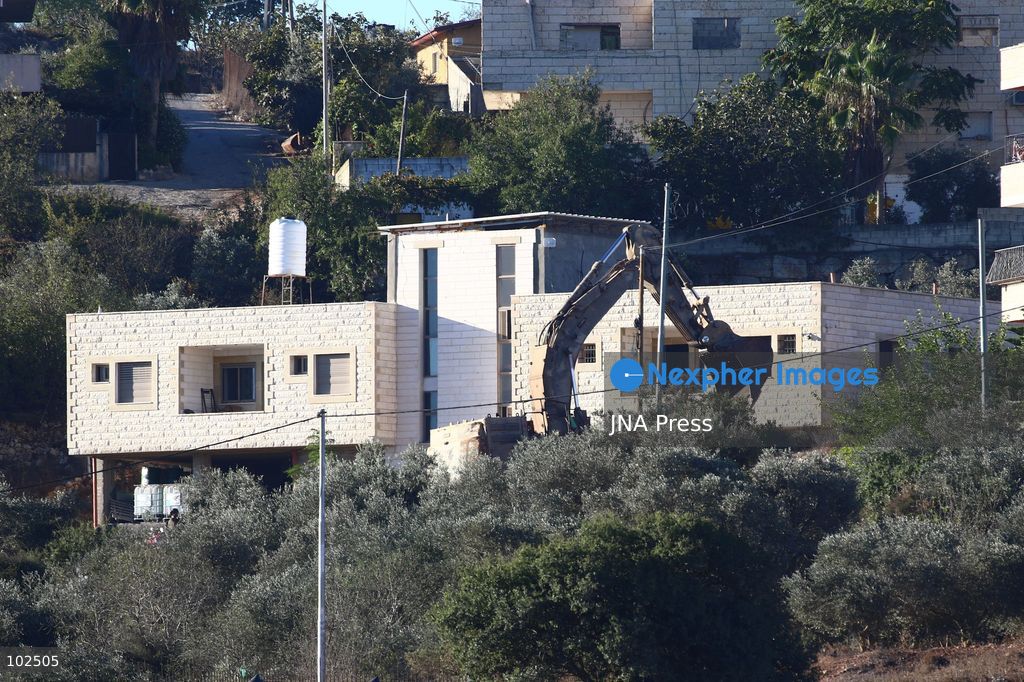 BIDDU, OCCUPIED WEST BANK, OCTOBER 7, 2026: Israeli forces accompanied by military bulldozers and engineering units demolish the home of Palestinian prisoner Qadri Samara in Biddu, northwest of Jerusalem. Israeli forces evacuated the house and surrounding homes before demolishing parts of the building and destroying it with controlled explosions. Israeli authorities accuse Samara of carrying out a shooting attack near the Israeli settlement of Neve Tzuf, also known as Halamish, in which an Israeli was killed. The demolition took place during a wider Israeli military operation involving raids, arrests and movement restrictions in several Palestinian towns and villages northwest of Jerusalem. Photo by Salman Mohsen Alkhatib / JNA Press. (Photo by Salman Mohsen Alkhatib/JNA Press via Nexpher Images)