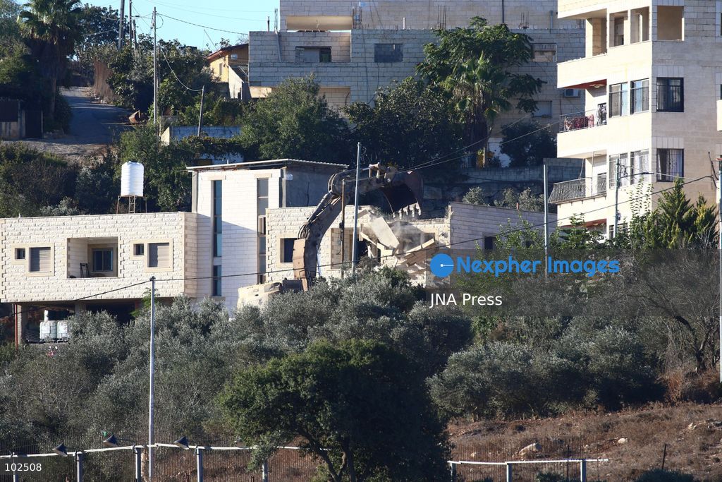 BIDDU, OCCUPIED WEST BANK, OCTOBER 7, 2026: Israeli forces accompanied by military bulldozers and engineering units demolish the home of Palestinian prisoner Qadri Samara in Biddu, northwest of Jerusalem. Israeli forces evacuated the house and surrounding homes before demolishing parts of the building and destroying it with controlled explosions. Israeli authorities accuse Samara of carrying out a shooting attack near the Israeli settlement of Neve Tzuf, also known as Halamish, in which an Israeli was killed. The demolition took place during a wider Israeli military operation involving raids, arrests and movement restrictions in several Palestinian towns and villages northwest of Jerusalem. Photo by Salman Mohsen Alkhatib / JNA Press. (Photo by Salman Mohsen Alkhatib/JNA Press via Nexpher Images)