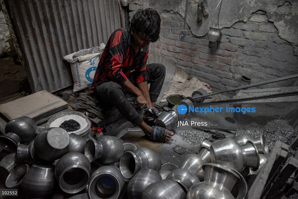 KERANIGANJ, DHAKA, BANGLADESH, OCTOBER 7, 2026: Young workers carry out manual tasks inside aluminum factories in the Zinjira industrial area of Keraniganj, near Dhaka. Sanaullah, believed to be around nine or 10 years old, says he works from 8 a.m. until 7 p.m. and earns about 1,400 Bangladeshi taka ($11) a month. Children are seen grinding and handling metal products inside workshops where workers are exposed to heat, smoke, metal dust, machinery and sharp equipment, with limited protective gear visible. The long working hours also leave little time for regular schooling. Photo by Bipul Ahmed / JNA Press. (Photo by Bipul Ahmed/JNA Press via Nexpher Images)