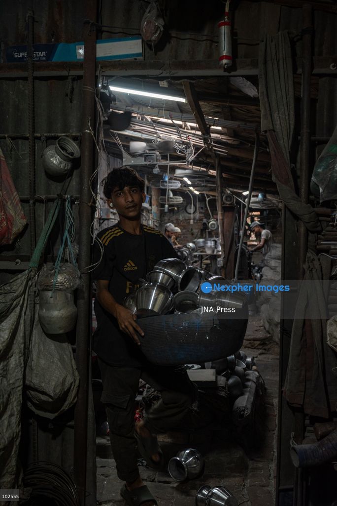 KERANIGANJ, DHAKA, BANGLADESH, OCTOBER 7, 2026: Young workers carry out manual tasks inside aluminum factories in the Zinjira industrial area of Keraniganj, near Dhaka. Sanaullah, believed to be around nine or 10 years old, says he works from 8 a.m. until 7 p.m. and earns about 1,400 Bangladeshi taka ($11) a month. Children are seen grinding and handling metal products inside workshops where workers are exposed to heat, smoke, metal dust, machinery and sharp equipment, with limited protective gear visible. The long working hours also leave little time for regular schooling. Photo by Bipul Ahmed / JNA Press. (Photo by Bipul Ahmed/JNA Press via Nexpher Images)