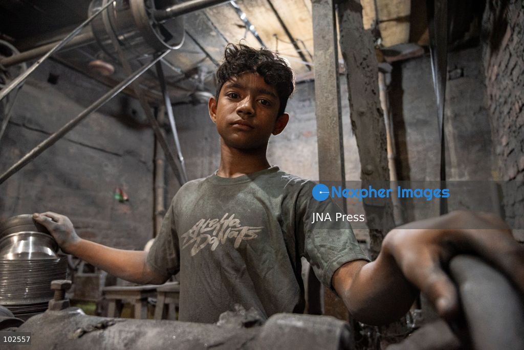 KERANIGANJ, DHAKA, BANGLADESH, OCTOBER 7, 2026: Young workers carry out manual tasks inside aluminum factories in the Zinjira industrial area of Keraniganj, near Dhaka. Sanaullah, believed to be around nine or 10 years old, says he works from 8 a.m. until 7 p.m. and earns about 1,400 Bangladeshi taka ($11) a month. Children are seen grinding and handling metal products inside workshops where workers are exposed to heat, smoke, metal dust, machinery and sharp equipment, with limited protective gear visible. The long working hours also leave little time for regular schooling. Photo by Bipul Ahmed / JNA Press. (Photo by Bipul Ahmed/JNA Press via Nexpher Images)