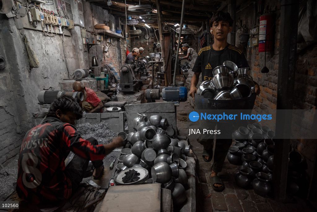 KERANIGANJ, DHAKA, BANGLADESH, OCTOBER 7, 2026: Young workers carry out manual tasks inside aluminum factories in the Zinjira industrial area of Keraniganj, near Dhaka. Sanaullah, believed to be around nine or 10 years old, says he works from 8 a.m. until 7 p.m. and earns about 1,400 Bangladeshi taka ($11) a month. Children are seen grinding and handling metal products inside workshops where workers are exposed to heat, smoke, metal dust, machinery and sharp equipment, with limited protective gear visible. The long working hours also leave little time for regular schooling. Photo by Bipul Ahmed / JNA Press. (Photo by Bipul Ahmed/JNA Press via Nexpher Images)