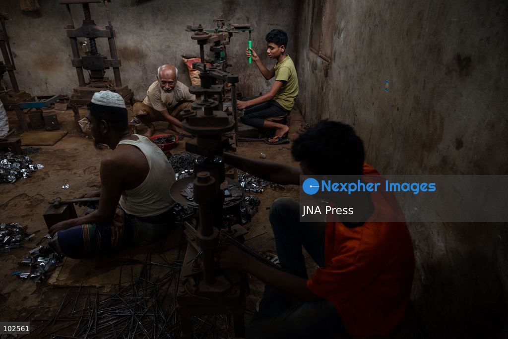 KERANIGANJ, DHAKA, BANGLADESH, OCTOBER 7, 2026: Young workers carry out manual tasks inside aluminum factories in the Zinjira industrial area of Keraniganj, near Dhaka. Sanaullah, believed to be around nine or 10 years old, says he works from 8 a.m. until 7 p.m. and earns about 1,400 Bangladeshi taka ($11) a month. Children are seen grinding and handling metal products inside workshops where workers are exposed to heat, smoke, metal dust, machinery and sharp equipment, with limited protective gear visible. The long working hours also leave little time for regular schooling. Photo by Bipul Ahmed / JNA Press. (Photo by Bipul Ahmed/JNA Press via Nexpher Images)