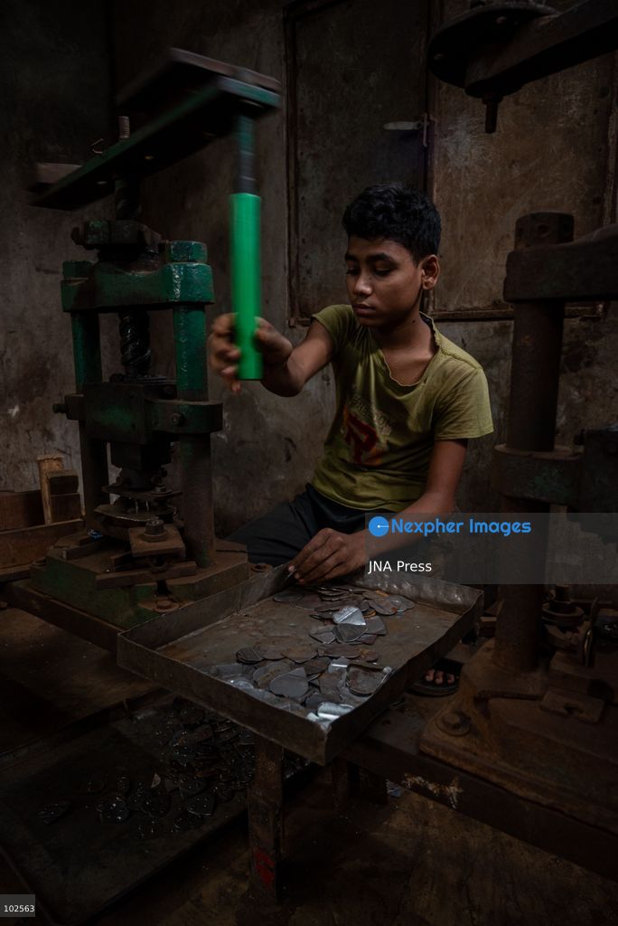 KERANIGANJ, DHAKA, BANGLADESH, OCTOBER 7, 2026: Young workers carry out manual tasks inside aluminum factories in the Zinjira industrial area of Keraniganj, near Dhaka. Sanaullah, believed to be around nine or 10 years old, says he works from 8 a.m. until 7 p.m. and earns about 1,400 Bangladeshi taka ($11) a month. Children are seen grinding and handling metal products inside workshops where workers are exposed to heat, smoke, metal dust, machinery and sharp equipment, with limited protective gear visible. The long working hours also leave little time for regular schooling. Photo by Bipul Ahmed / JNA Press. (Photo by Bipul Ahmed/JNA Press via Nexpher Images)