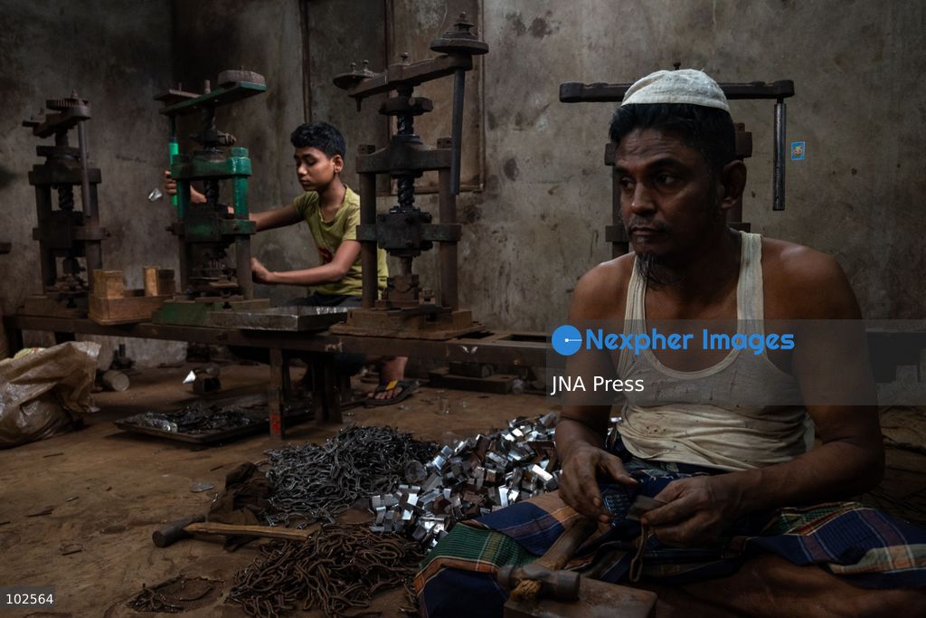 KERANIGANJ, DHAKA, BANGLADESH, OCTOBER 7, 2026: Young workers carry out manual tasks inside aluminum factories in the Zinjira industrial area of Keraniganj, near Dhaka. Sanaullah, believed to be around nine or 10 years old, says he works from 8 a.m. until 7 p.m. and earns about 1,400 Bangladeshi taka ($11) a month. Children are seen grinding and handling metal products inside workshops where workers are exposed to heat, smoke, metal dust, machinery and sharp equipment, with limited protective gear visible. The long working hours also leave little time for regular schooling. Photo by Bipul Ahmed / JNA Press. (Photo by Bipul Ahmed/JNA Press via Nexpher Images)