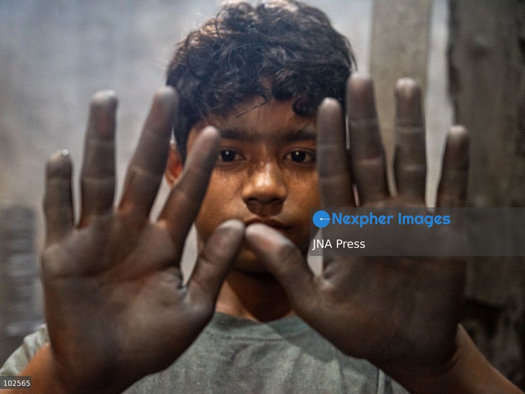 KERANIGANJ, DHAKA, BANGLADESH, OCTOBER 7, 2026: Young workers carry out manual tasks inside aluminum factories in the Zinjira industrial area of Keraniganj, near Dhaka. Sanaullah, believed to be around nine or 10 years old, says he works from 8 a.m. until 7 p.m. and earns about 1,400 Bangladeshi taka ($11) a month. Children are seen grinding and handling metal products inside workshops where workers are exposed to heat, smoke, metal dust, machinery and sharp equipment, with limited protective gear visible. The long working hours also leave little time for regular schooling. Photo by Bipul Ahmed / JNA Press. (Photo by Bipul Ahmed/JNA Press via Nexpher Images)