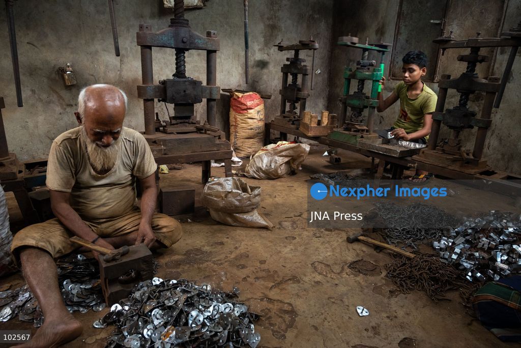 KERANIGANJ, DHAKA, BANGLADESH, OCTOBER 7, 2026: Young workers carry out manual tasks inside aluminum factories in the Zinjira industrial area of Keraniganj, near Dhaka. Sanaullah, believed to be around nine or 10 years old, says he works from 8 a.m. until 7 p.m. and earns about 1,400 Bangladeshi taka ($11) a month. Children are seen grinding and handling metal products inside workshops where workers are exposed to heat, smoke, metal dust, machinery and sharp equipment, with limited protective gear visible. The long working hours also leave little time for regular schooling. Photo by Bipul Ahmed / JNA Press. (Photo by Bipul Ahmed/JNA Press via Nexpher Images)