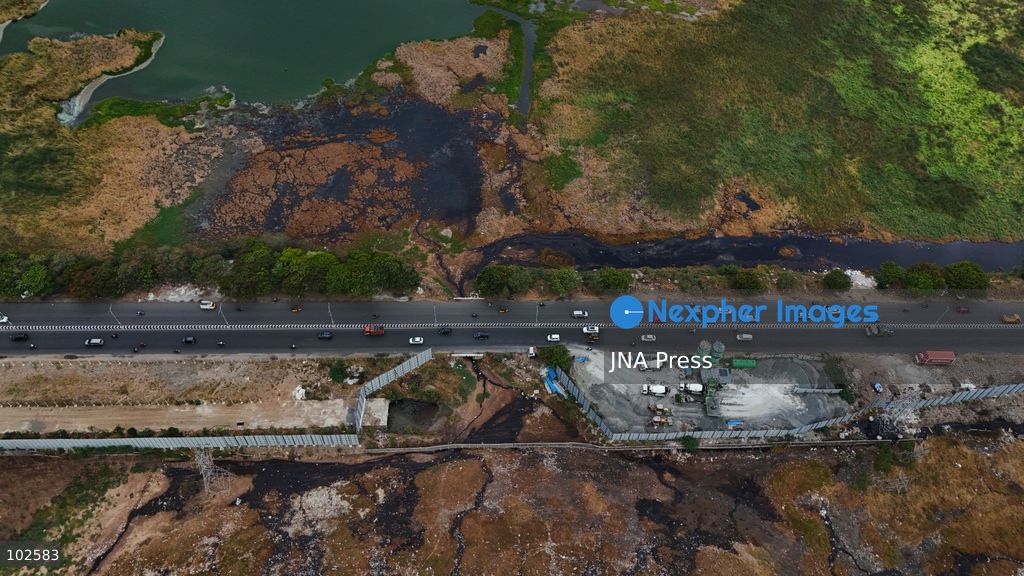 CHENNAI, INDIA, OCTOBER 7, 2026: Dark brown discolored water is seen near a landfill at the Pallikaranai marshland in Chennai in an aerial view. Local residents have raised concerns over pollution in the wetland and reported foul odours from the area, calling on authorities to investigate the source of the discoloration and take action to protect the marshland. Pallikaranai is an important urban wetland and habitat for a wide range of wildlife. Photo by Lucas M / JNA Press. (Photo by Lucas M/JNA Press via Nexpher Images)