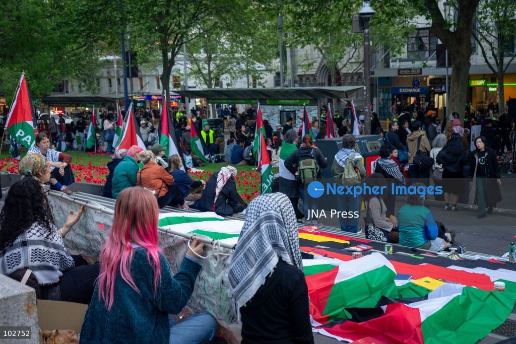 MELBOURNE, AUSTRALIA – OCTOBER 7, 2026: A day-long vigil in solidarity with the people of Gaza was held at the State Library of Victoria, with attendees taking part in a sit-in from 10:00 AM to 5:00 PM, followed by a commemoration from 5:00 PM to 6:00 PM to honour and remember people killed in Gaza. During the vigil, attendees made paper poppies and placed them throughout the garden in front of the library. A car marked with numerous bullet holes, presented as a representation of the vehicle in which Hind Rajab was trapped and killed in Gaza, was displayed at the site. A recording of Rajab's final call for help was also played over a speaker. The names and ages of people who had died were read aloud during the commemoration. Photo by Huda Shehzad / JNA Press. (Photo by Huda Shehzad/JNA Press via Nexpher Images)