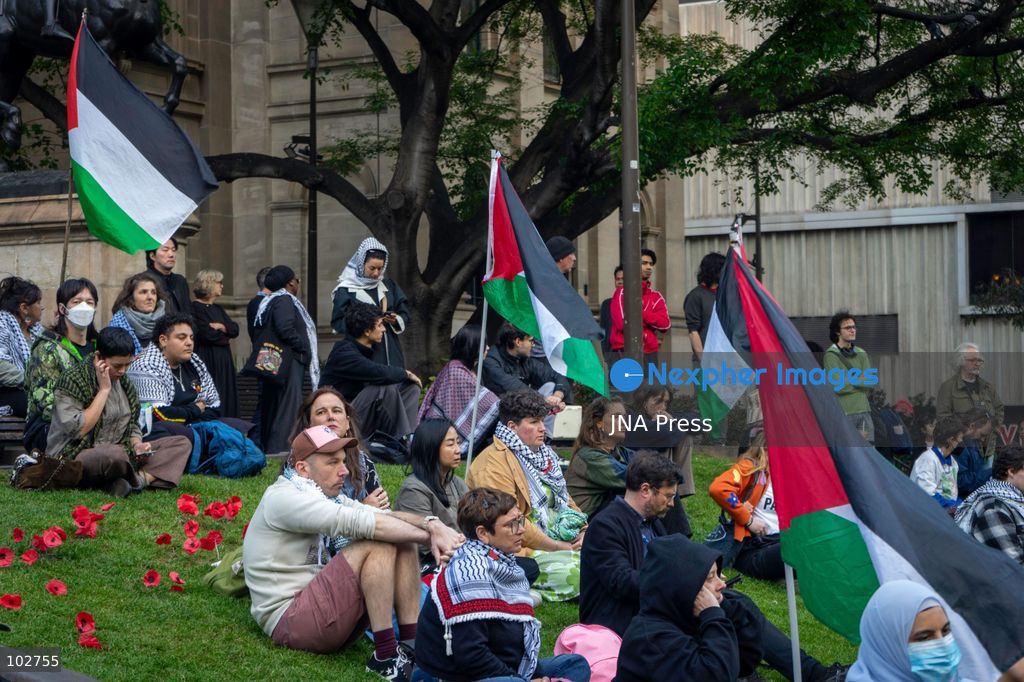 MELBOURNE, AUSTRALIA – OCTOBER 7, 2026: A day-long vigil in solidarity with the people of Gaza was held at the State Library of Victoria, with attendees taking part in a sit-in from 10:00 AM to 5:00 PM, followed by a commemoration from 5:00 PM to 6:00 PM to honour and remember people killed in Gaza. During the vigil, attendees made paper poppies and placed them throughout the garden in front of the library. A car marked with numerous bullet holes, presented as a representation of the vehicle in which Hind Rajab was trapped and killed in Gaza, was displayed at the site. A recording of Rajab's final call for help was also played over a speaker. The names and ages of people who had died were read aloud during the commemoration. Photo by Huda Shehzad / JNA Press. (Photo by Huda Shehzad/JNA Press via Nexpher Images)