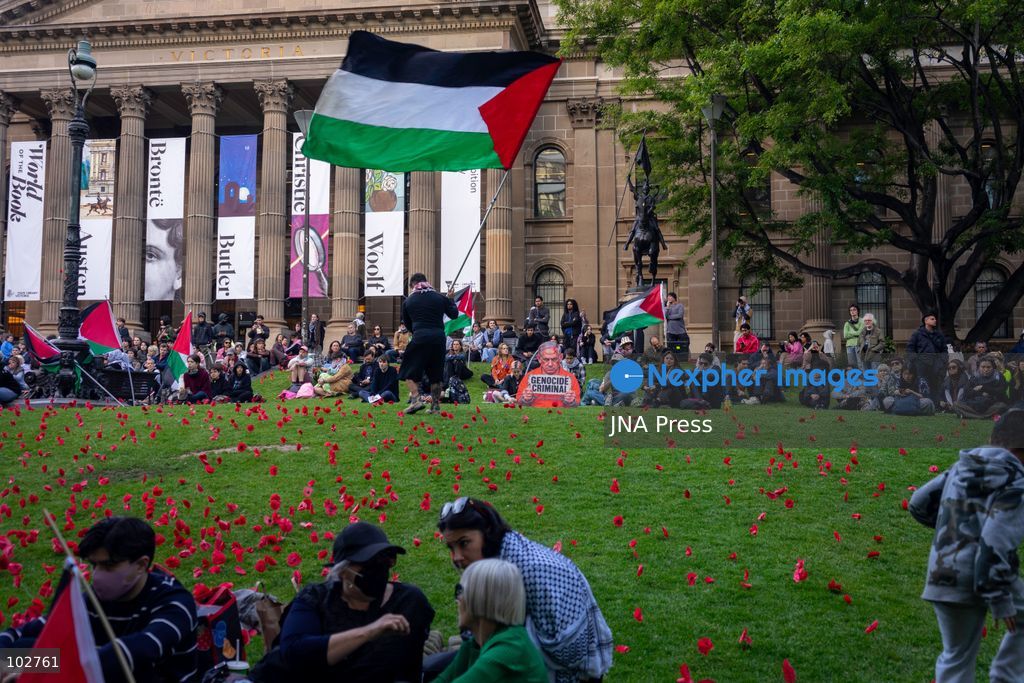 MELBOURNE, AUSTRALIA – OCTOBER 7, 2026: A day-long vigil in solidarity with the people of Gaza was held at the State Library of Victoria, with attendees taking part in a sit-in from 10:00 AM to 5:00 PM, followed by a commemoration from 5:00 PM to 6:00 PM to honour and remember people killed in Gaza. During the vigil, attendees made paper poppies and placed them throughout the garden in front of the library. A car marked with numerous bullet holes, presented as a representation of the vehicle in which Hind Rajab was trapped and killed in Gaza, was displayed at the site. A recording of Rajab's final call for help was also played over a speaker. The names and ages of people who had died were read aloud during the commemoration. Photo by Huda Shehzad / JNA Press. (Photo by Huda Shehzad/JNA Press via Nexpher Images)