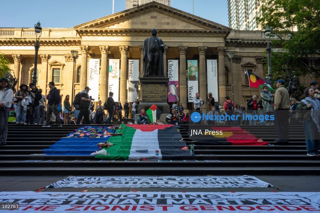 MELBOURNE, AUSTRALIA – OCTOBER 7, 2026: A day-long vigil in solidarity with the people of Gaza was held at the State Library of Victoria, with attendees taking part in a sit-in from 10:00 AM to 5:00 PM, followed by a commemoration from 5:00 PM to 6:00 PM to honour and remember people killed in Gaza. During the vigil, attendees made paper poppies and placed them throughout the garden in front of the library. A car marked with numerous bullet holes, presented as a representation of the vehicle in which Hind Rajab was trapped and killed in Gaza, was displayed at the site. A recording of Rajab's final call for help was also played over a speaker. The names and ages of people who had died were read aloud during the commemoration. Photo by Huda Shehzad / JNA Press. (Photo by Huda Shehzad/JNA Press via Nexpher Images)