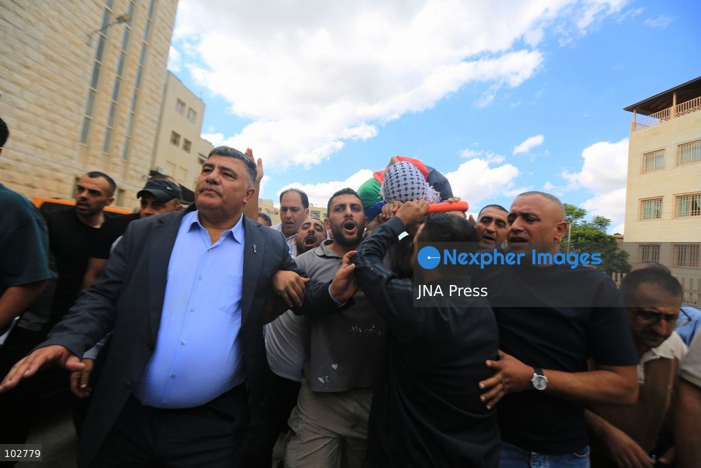 BURQA, NABLUS, PALESTINE – OCTOBER 7, 2026: A large crowd accompanies the body of Ali Hassan Yasser al-Bazari, 44, to his final resting place in the village of Burqa, north of Nablus. The funeral procession departed from Rafidia Hospital and continued to al-Bazari’s home in Burqa, where his family and residents gathered for a final farewell before prayers were held at a local mosque and his body was buried in the village cemetery. Al-Bazari was killed during an attack by Israeli settlers, according to Palestinian authorities, on olive pickers from Burqa in agricultural areas extending between the village and the Ramin Plain east of Tulkarm. He was struck by live ammunition in the lower back and later died from his wounds. The Palestinian Ministry of Health said 16 other people were injured by live ammunition and physical assault during the incident. Photo by Ali Shtayeh / JNA Press. (Photo by ALI Shtayeh/JNA Press via Nexpher Images)