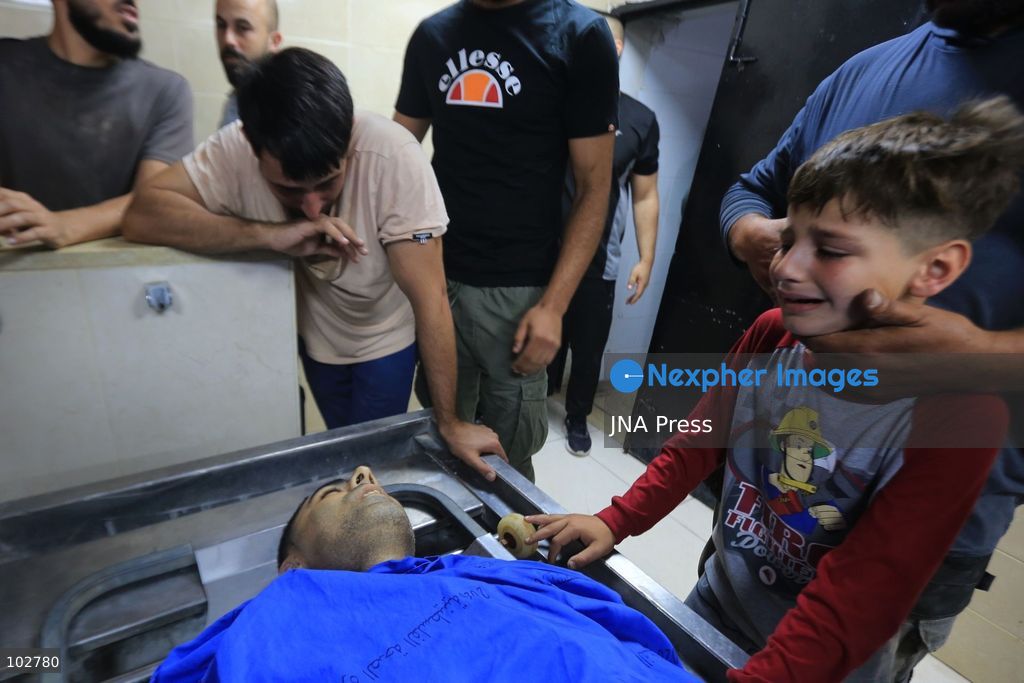BURQA, NABLUS, PALESTINE – OCTOBER 7, 2026: A large crowd accompanies the body of Ali Hassan Yasser al-Bazari, 44, to his final resting place in the village of Burqa, north of Nablus. The funeral procession departed from Rafidia Hospital and continued to al-Bazari’s home in Burqa, where his family and residents gathered for a final farewell before prayers were held at a local mosque and his body was buried in the village cemetery. Al-Bazari was killed during an attack by Israeli settlers, according to Palestinian authorities, on olive pickers from Burqa in agricultural areas extending between the village and the Ramin Plain east of Tulkarm. He was struck by live ammunition in the lower back and later died from his wounds. The Palestinian Ministry of Health said 16 other people were injured by live ammunition and physical assault during the incident. Photo by Ali Shtayeh / JNA Press. (Photo by ALI Shtayeh/JNA Press via Nexpher Images)