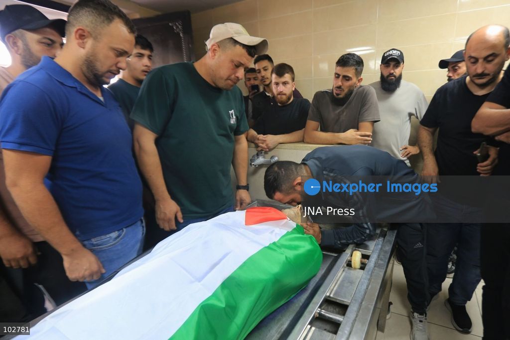 BURQA, NABLUS, PALESTINE – OCTOBER 7, 2026: A large crowd accompanies the body of Ali Hassan Yasser al-Bazari, 44, to his final resting place in the village of Burqa, north of Nablus. The funeral procession departed from Rafidia Hospital and continued to al-Bazari’s home in Burqa, where his family and residents gathered for a final farewell before prayers were held at a local mosque and his body was buried in the village cemetery. Al-Bazari was killed during an attack by Israeli settlers, according to Palestinian authorities, on olive pickers from Burqa in agricultural areas extending between the village and the Ramin Plain east of Tulkarm. He was struck by live ammunition in the lower back and later died from his wounds. The Palestinian Ministry of Health said 16 other people were injured by live ammunition and physical assault during the incident. Photo by Ali Shtayeh / JNA Press. (Photo by ALI Shtayeh/JNA Press via Nexpher Images)