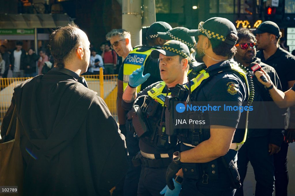 MELBOURNE, AUSTRALIA – OCTOBER 7, 2026: A vigil in solidarity with the people of Gaza was held at the State Library of Victoria, with attendees participating in a sit-in from 10:00 AM to 5:00 PM, followed by a commemoration event from 5:00 PM to 6:00 PM to remember those killed. During the event, Avi Yemini of Rebel News Australia arrived with a crew seeking interviews with attendees. Police formed a barricade, while event marshals and police maintained a line to prevent Yemini and his crew from entering the vigil area. According to event organizers, Yemini repeatedly collided with police and attempted to evade the barricade. Photo by Huda Shehzad / JNA Press. (Photo by Huda Shehzad/JNA Press via Nexpher Images)