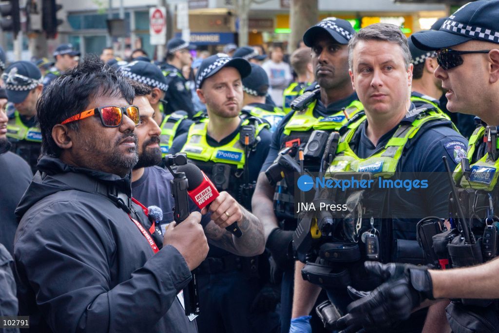 MELBOURNE, AUSTRALIA – OCTOBER 7, 2026: A vigil in solidarity with the people of Gaza was held at the State Library of Victoria, with attendees participating in a sit-in from 10:00 AM to 5:00 PM, followed by a commemoration event from 5:00 PM to 6:00 PM to remember those killed. During the event, Avi Yemini of Rebel News Australia arrived with a crew seeking interviews with attendees. Police formed a barricade, while event marshals and police maintained a line to prevent Yemini and his crew from entering the vigil area. According to event organizers, Yemini repeatedly collided with police and attempted to evade the barricade. Photo by Huda Shehzad / JNA Press. (Photo by Huda Shehzad/JNA Press via Nexpher Images)