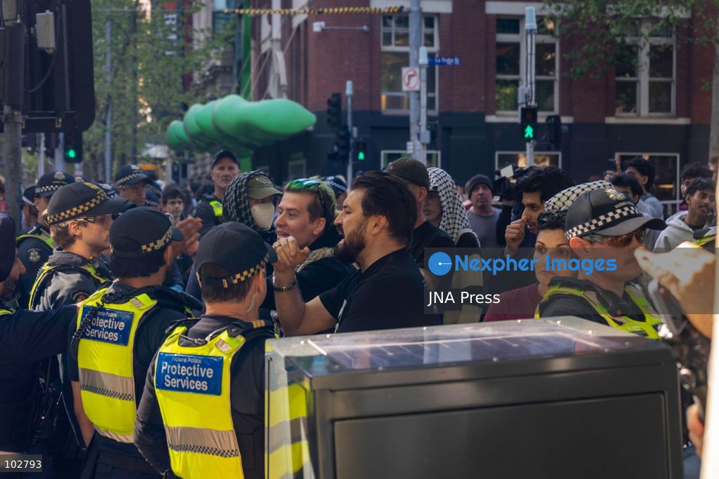 MELBOURNE, AUSTRALIA – OCTOBER 7, 2026: A vigil in solidarity with the people of Gaza was held at the State Library of Victoria, with attendees participating in a sit-in from 10:00 AM to 5:00 PM, followed by a commemoration event from 5:00 PM to 6:00 PM to remember those killed. During the event, Avi Yemini of Rebel News Australia arrived with a crew seeking interviews with attendees. Police formed a barricade, while event marshals and police maintained a line to prevent Yemini and his crew from entering the vigil area. According to event organizers, Yemini repeatedly collided with police and attempted to evade the barricade. Photo by Huda Shehzad / JNA Press. (Photo by Huda Shehzad/JNA Press via Nexpher Images)