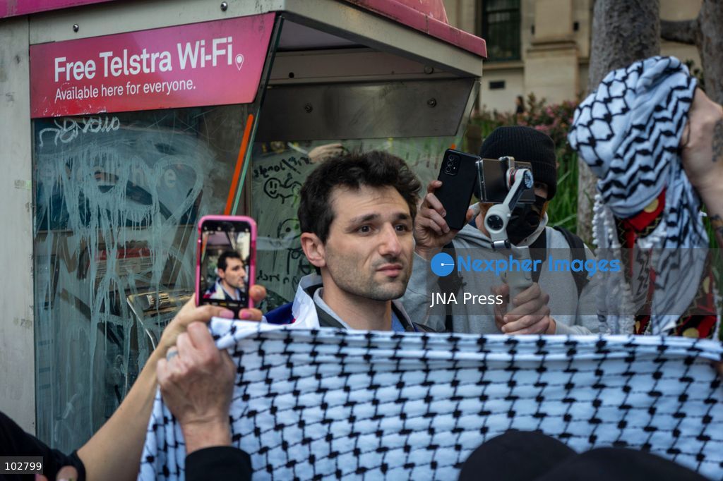 MELBOURNE, AUSTRALIA – OCTOBER 7, 2026: A vigil in solidarity with the people of Gaza was held at the State Library of Victoria, with attendees participating in a sit-in from 10:00 AM to 5:00 PM, followed by a commemoration event from 5:00 PM to 6:00 PM to remember those killed. During the event, Avi Yemini of Rebel News Australia arrived with a crew seeking interviews with attendees. Police formed a barricade, while event marshals and police maintained a line to prevent Yemini and his crew from entering the vigil area. According to event organizers, Yemini repeatedly collided with police and attempted to evade the barricade. Photo by Huda Shehzad / JNA Press. (Photo by Huda Shehzad/JNA Press via Nexpher Images)