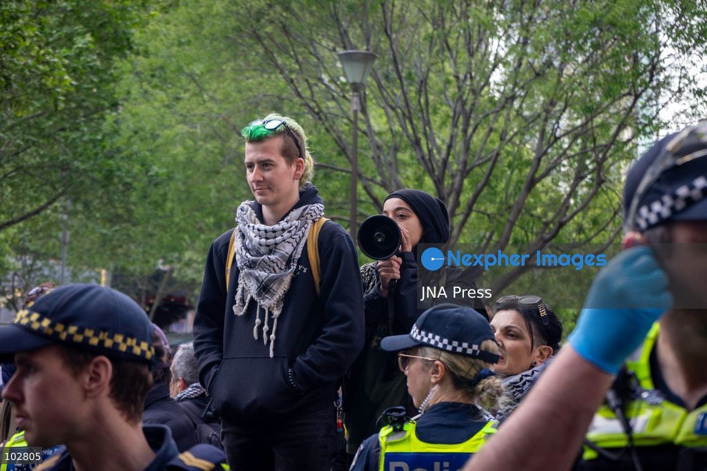 MELBOURNE, AUSTRALIA – OCTOBER 7, 2026: A vigil in solidarity with the people of Gaza was held at the State Library of Victoria, with attendees participating in a sit-in from 10:00 AM to 5:00 PM, followed by a commemoration event from 5:00 PM to 6:00 PM to remember those killed. During the event, Avi Yemini of Rebel News Australia arrived with a crew seeking interviews with attendees. Police formed a barricade, while event marshals and police maintained a line to prevent Yemini and his crew from entering the vigil area. According to event organizers, Yemini repeatedly collided with police and attempted to evade the barricade. Photo by Huda Shehzad / JNA Press. (Photo by Huda Shehzad/JNA Press via Nexpher Images)