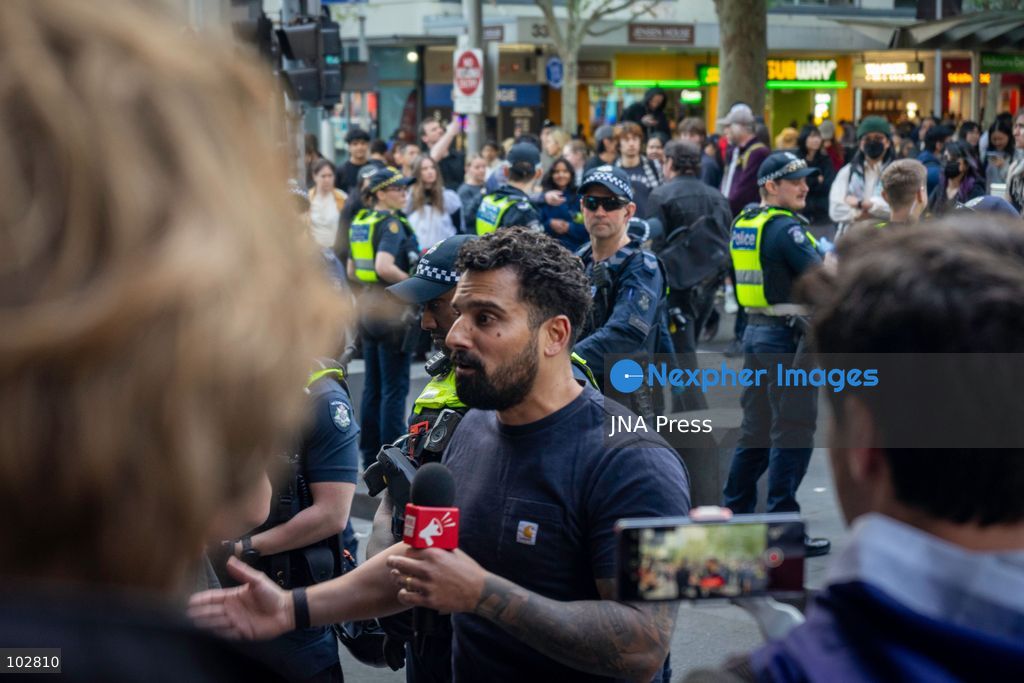MELBOURNE, AUSTRALIA – OCTOBER 7, 2026: A vigil in solidarity with the people of Gaza was held at the State Library of Victoria, with attendees participating in a sit-in from 10:00 AM to 5:00 PM, followed by a commemoration event from 5:00 PM to 6:00 PM to remember those killed. During the event, Avi Yemini of Rebel News Australia arrived with a crew seeking interviews with attendees. Police formed a barricade, while event marshals and police maintained a line to prevent Yemini and his crew from entering the vigil area. According to event organizers, Yemini repeatedly collided with police and attempted to evade the barricade. Photo by Huda Shehzad / JNA Press. (Photo by Huda Shehzad/JNA Press via Nexpher Images)