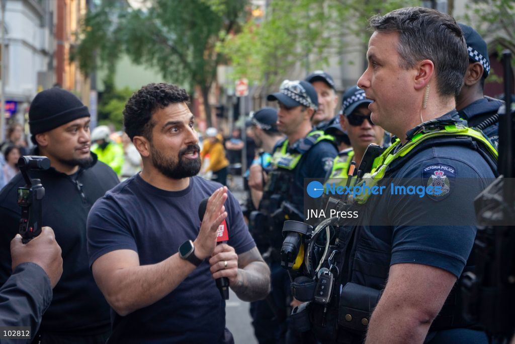 MELBOURNE, AUSTRALIA – OCTOBER 7, 2026: A vigil in solidarity with the people of Gaza was held at the State Library of Victoria, with attendees participating in a sit-in from 10:00 AM to 5:00 PM, followed by a commemoration event from 5:00 PM to 6:00 PM to remember those killed. During the event, Avi Yemini of Rebel News Australia arrived with a crew seeking interviews with attendees. Police formed a barricade, while event marshals and police maintained a line to prevent Yemini and his crew from entering the vigil area. According to event organizers, Yemini repeatedly collided with police and attempted to evade the barricade. Photo by Huda Shehzad / JNA Press. (Photo by Huda Shehzad/JNA Press via Nexpher Images)