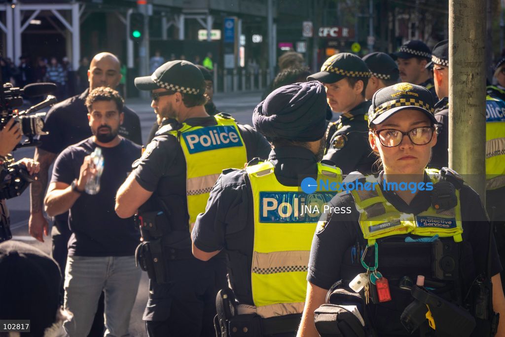 MELBOURNE, AUSTRALIA – OCTOBER 7, 2026: A vigil in solidarity with the people of Gaza was held at the State Library of Victoria, with attendees participating in a sit-in from 10:00 AM to 5:00 PM, followed by a commemoration event from 5:00 PM to 6:00 PM to remember those killed. During the event, Avi Yemini of Rebel News Australia arrived with a crew seeking interviews with attendees. Police formed a barricade, while event marshals and police maintained a line to prevent Yemini and his crew from entering the vigil area. According to event organizers, Yemini repeatedly collided with police and attempted to evade the barricade. Photo by Huda Shehzad / JNA Press. (Photo by Huda Shehzad/JNA Press via Nexpher Images)