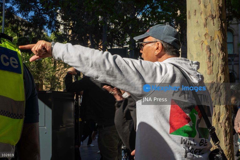 MELBOURNE, AUSTRALIA – OCTOBER 7, 2026: A vigil in solidarity with the people of Gaza was held at the State Library of Victoria, with attendees participating in a sit-in from 10:00 AM to 5:00 PM, followed by a commemoration event from 5:00 PM to 6:00 PM to remember those killed. During the event, Avi Yemini of Rebel News Australia arrived with a crew seeking interviews with attendees. Police formed a barricade, while event marshals and police maintained a line to prevent Yemini and his crew from entering the vigil area. According to event organizers, Yemini repeatedly collided with police and attempted to evade the barricade. Photo by Huda Shehzad / JNA Press. (Photo by Huda Shehzad/JNA Press via Nexpher Images)