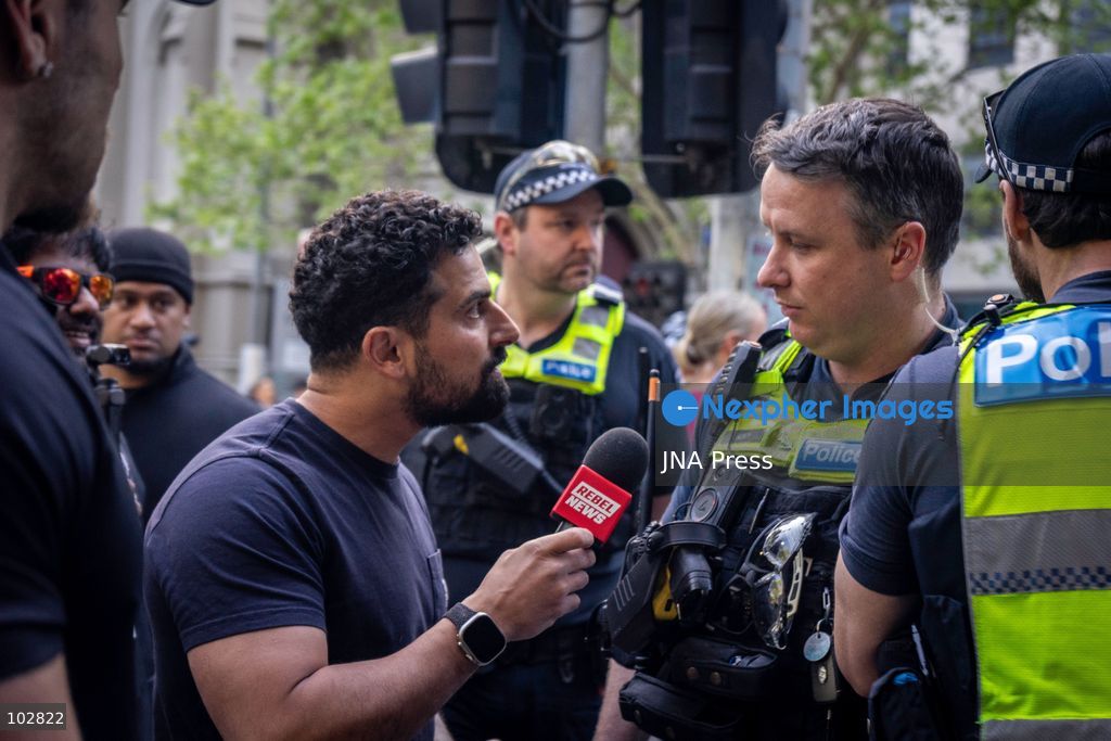 MELBOURNE, AUSTRALIA – OCTOBER 7, 2026: A vigil in solidarity with the people of Gaza was held at the State Library of Victoria, with attendees participating in a sit-in from 10:00 AM to 5:00 PM, followed by a commemoration event from 5:00 PM to 6:00 PM to remember those killed. During the event, Avi Yemini of Rebel News Australia arrived with a crew seeking interviews with attendees. Police formed a barricade, while event marshals and police maintained a line to prevent Yemini and his crew from entering the vigil area. According to event organizers, Yemini repeatedly collided with police and attempted to evade the barricade. Photo by Huda Shehzad / JNA Press. (Photo by Huda Shehzad/JNA Press via Nexpher Images)