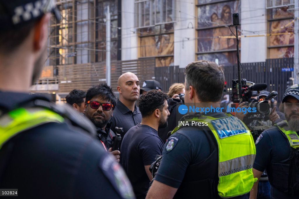 MELBOURNE, AUSTRALIA – OCTOBER 7, 2026: A vigil in solidarity with the people of Gaza was held at the State Library of Victoria, with attendees participating in a sit-in from 10:00 AM to 5:00 PM, followed by a commemoration event from 5:00 PM to 6:00 PM to remember those killed. During the event, Avi Yemini of Rebel News Australia arrived with a crew seeking interviews with attendees. Police formed a barricade, while event marshals and police maintained a line to prevent Yemini and his crew from entering the vigil area. According to event organizers, Yemini repeatedly collided with police and attempted to evade the barricade. Photo by Huda Shehzad / JNA Press. (Photo by Huda Shehzad/JNA Press via Nexpher Images)